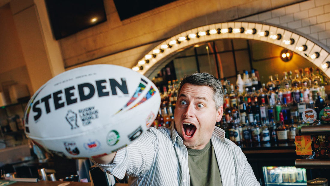 Lachlan Stevens holding a Steeden Rugby League World Cup ball at the His Boy Elroy bar, Wollongong